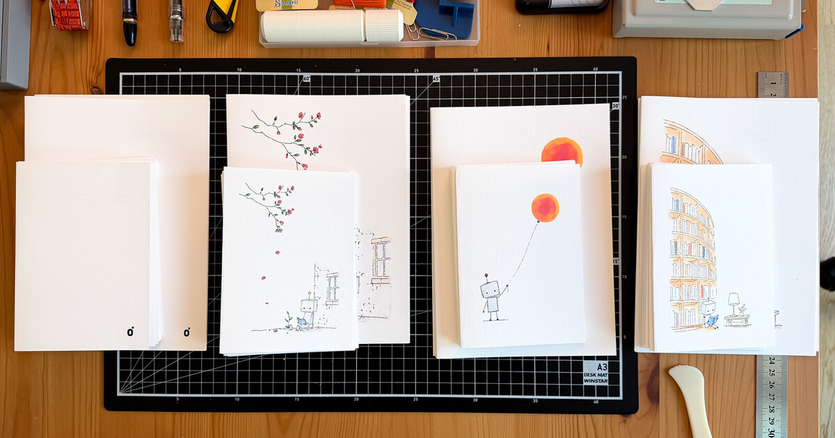 Studio Monjo hand-bound notebook editions arranged across the cutting table